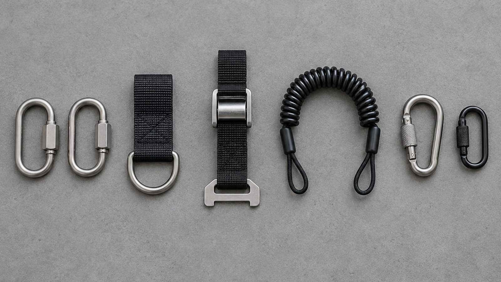 Tool tethering hardware components: quick rings, a D-ring adapter, a cinch tool attachment, a coiled tool lanyard and small locking connectors