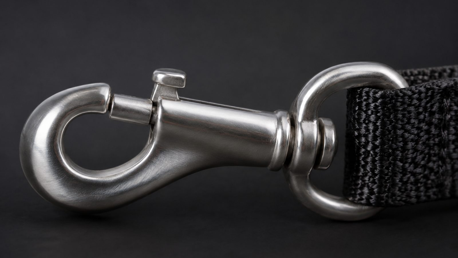Swivel bolt snap hook attached to nylon webbing, showing the sliding spring-loaded bolt